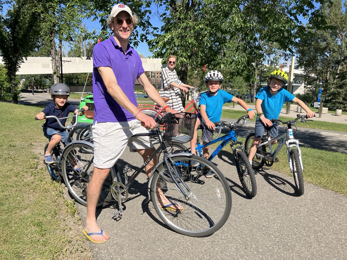Family riding rental bikes together on the Calgary pathway