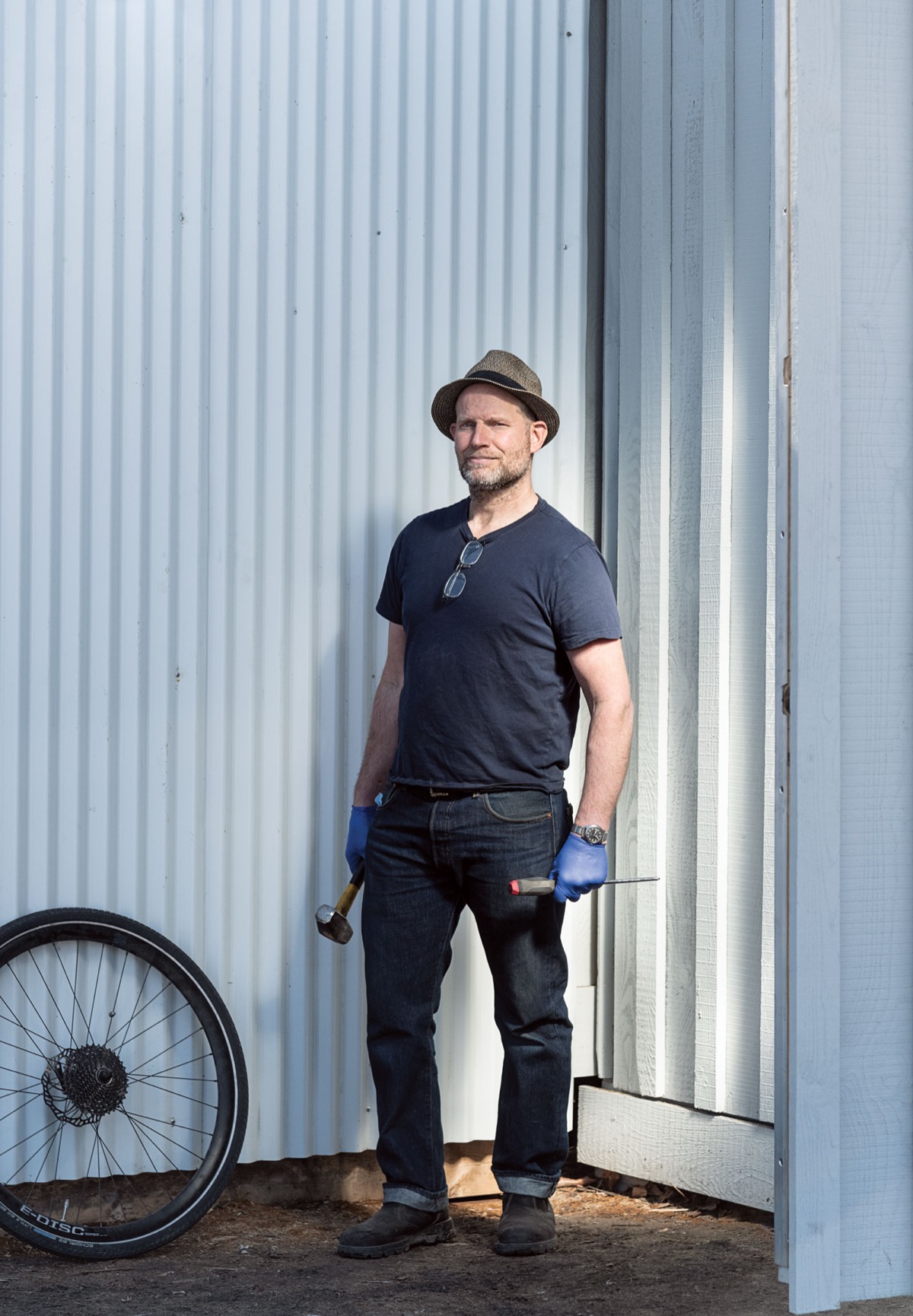 Joe Nunn — portrait by Jared Sych, leaning against the container shop