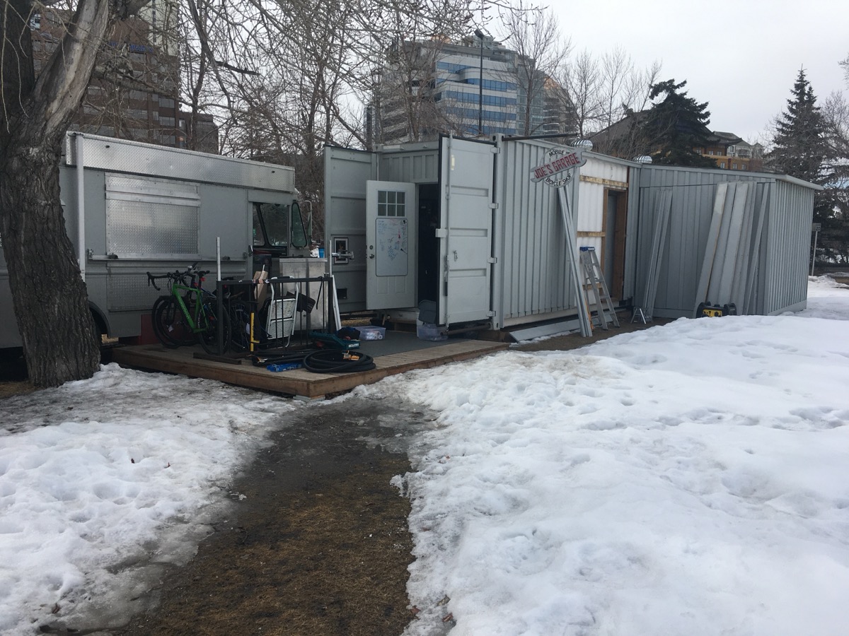 The container shop in winter with snow and bikes